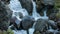 Water stream falling onto the boulders