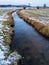 Water stream flowing in a field