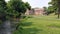 Water stream and the green at the Colonial Industrial Quarter, Historic mills and wash houses in the background, Bethlehem, PA