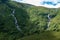 Water streams flowing down a green mountainside