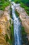 Water streeam on rocky wall in the mountains