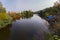 The water surface of the river with boats sailing in the distance in the direction of people resting on the summer area