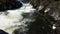 Water swirling at the bottom of a cascade in the rocky mountains