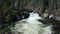 Water swirling at the bottom of a cascade in the rocky mountains