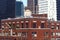 Water tank on the roof of an older building among skyscrapers in Midtown, New York