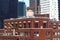 Water tank on the roof of an older building among skyscrapers in Midtown, New York