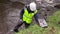 Water testing in river with workers wearing High-visibility clothing