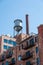 Water Tower on Old Brick Building with Metal Balconies