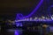 Water traffic by night under blue light bridge