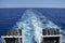Water trail foaming behind a ferry boat in Mediterranean sea