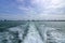 Water trail surface behind a ferry boat.