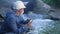 Water treatment engineer examines environmental pollution. Biologist with digital tablet examines water allergy. Worker