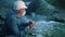 water treatment engineer examines environmental pollution sun. biologist with digital tablet examines water allergy