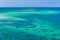 Water of tropical sea and tiny coral reef on background