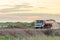 Water truck sprays water for a new road construction site