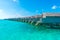 Water villas over calm sea in tropical Maldives island .