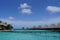 Water villas, sky and turquoise ocean on a clear sunny day