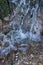 Water in a waterfall with algae