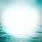 Water wave in blur background of natural wavy rippled sea or swimming pool surface in green blue color