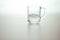 Water wave in transparent glass on gray background. fresh drink water on table