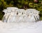 Water wine glasses lined up on a white table cloth