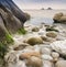 Water worn ancient rocks detail on beach