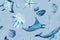 Watercolor hand-drawn monochromatic seamless pattern on blue. Blue whale, a manta ray, shells, a starfish ,a polyp and a