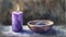 Watercolor illustration capturing the spirit of Ash Wednesday, featuring a purple candle beside an ash-filled bowl, calm