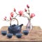 Watercolor illustration of japan tea ceremony, composition of dark blue ceramic teapot, bowls of tea, transparent vase
