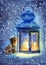 Watercolor illustration of a lit blue lantern with a candle inside, standing in the snow