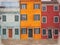 Watercolor image of row of colorful painted houses in Burano Venice