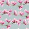 Watercolor magnolia seamless pattern. Hand painted flowers and green leaves on branch isolated on pastel blue background