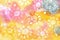 Watercolor painted little suns on pastel pink, yellow, gray abstract big spots background drawn by brush