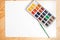 Watercolor paints and brushes, top view. Creative artistic mockup with copyspace