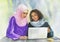 Watercolor portrait of Arabian and African women with laptop