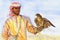 Watercolor portrait of arabian man. Hand drawn sheikh and predatory bird in desert
