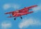 Watercolor red airplane on blue sky illustration with computer processing. view of a flying plane.