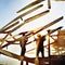 Watercolor of roofer working on roof structure at construction site