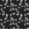 Watercolor seamless pattern with black and white leaf twigs, small leaves on a black background.