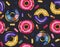 Watercolor seamless Pattern of cosmic donuts coated with glaze.