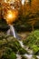 Waterfall in autumn with orange and yellow colors. Running clear, cold water in a forrest during autumn