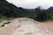 Waterfall in Ayn Khor  and Lush green landscape, trees and foggy mountains at tourist resort, Salalah, Oman