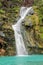 Waterfall in Ayn Khor and Lush green landscape, trees and foggy mountains at tourist resort, Salalah, Oman