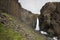 Waterfall and basaltic rocks in Iceland.
