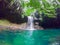 Waterfall in Bassin Paradise in Guadeloupe seen from water level