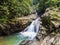 Waterfall with big rock bank in the tropical forest