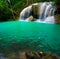 Waterfall and a blue pool with fish