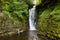 Waterfall in a canyon surrounded by green foliage Sgwd Einion Gam, Waterfall Country, Wales