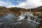 Waterfall cascade in the area of Gjain in Porsdalur in the Icelandic highlands. Oblue cloudy sky. Long exposure shot of the river.