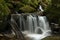 Waterfall, cascade between big rocks in ravine Ysperklamm